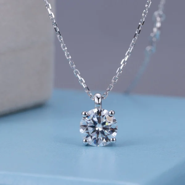 Allison Diamond Drop Necklace by Zomaco displayed on blue table in frontal view, highlighting its elegant design and diamond details