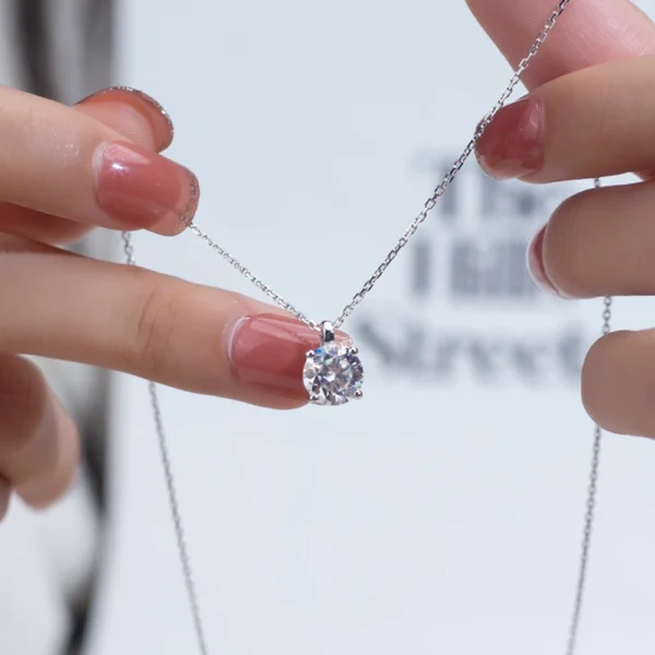 Allison Diamond Drop Necklace by Zomaco held by hands at both ends, emphasizing the elegance of the necklace