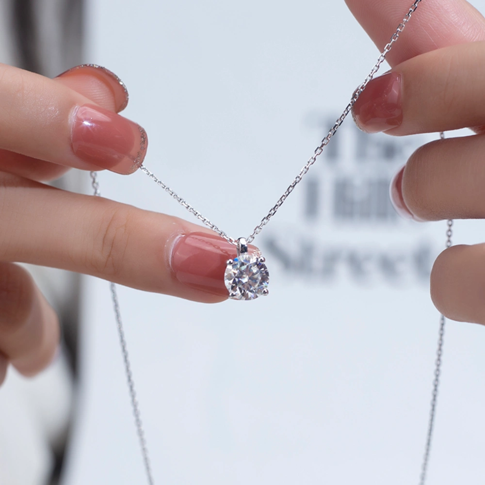 Allison Diamond Drop Necklace by Zomaco held by hands at both ends, emphasizing the elegance of the necklace