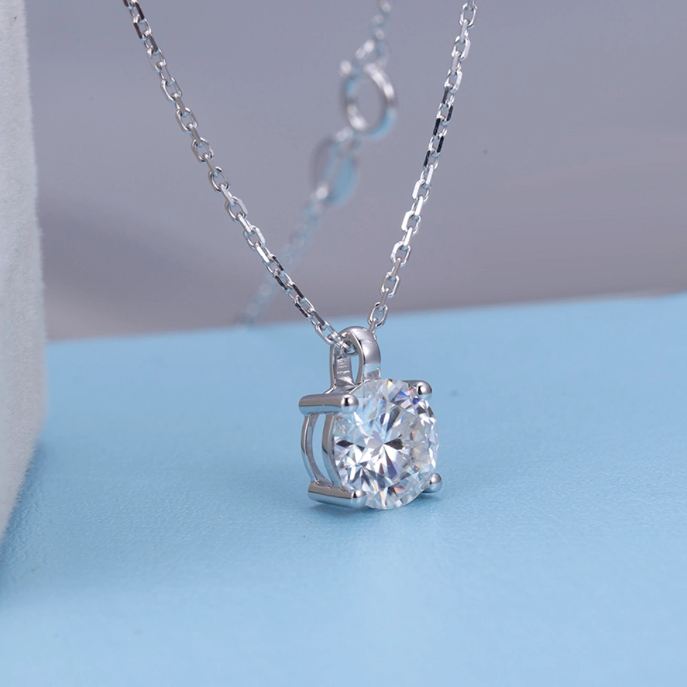 Allison Diamond Drop Necklace by Zomaco on a blue table in diagonal view - elegant and refined jewelry